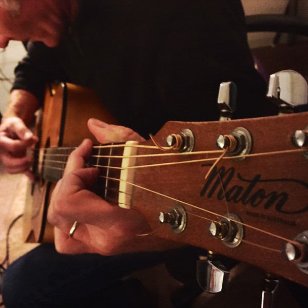 Closeup of Mark playing guitar